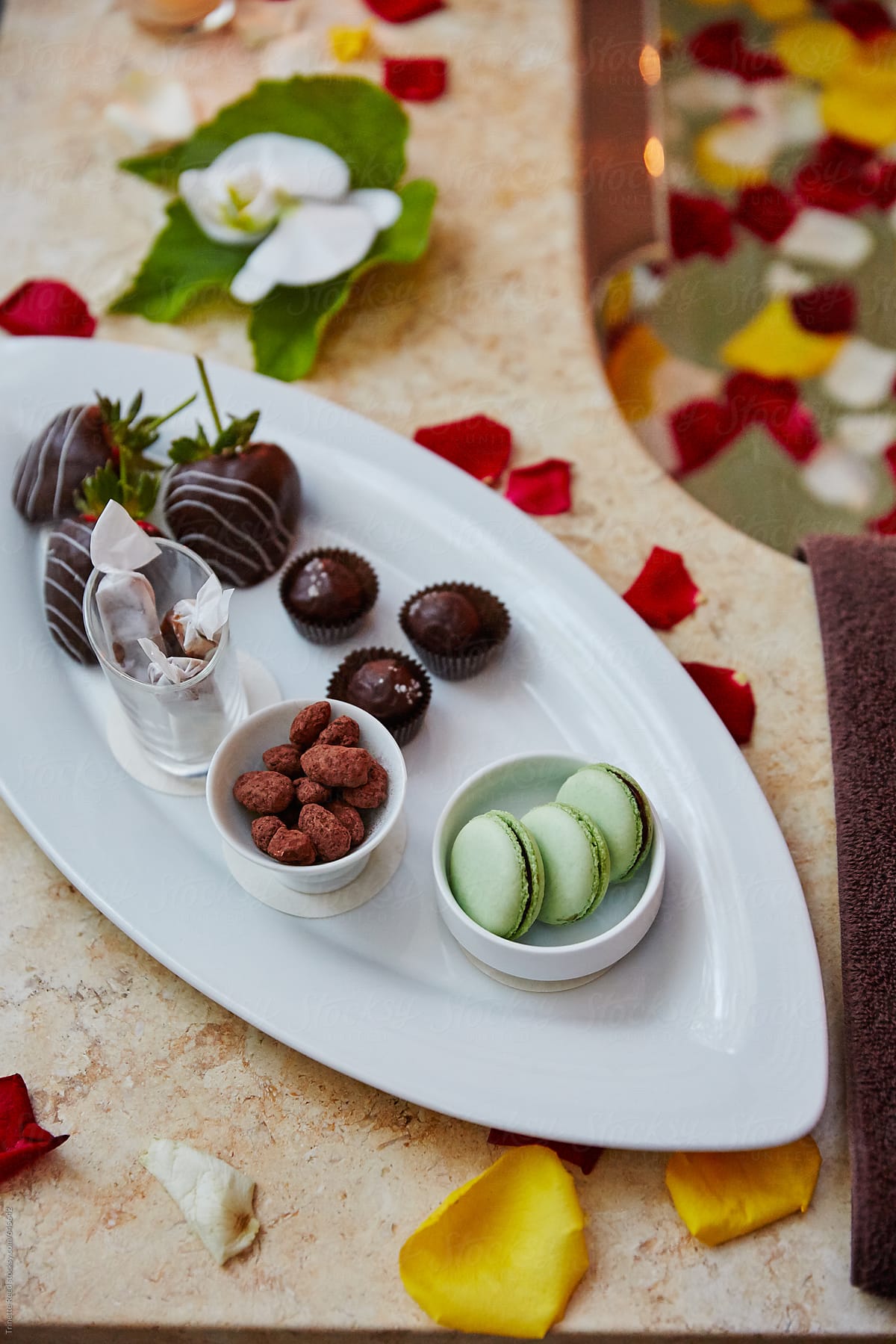 Sweet dessert treats on outdoor bathtub at luxury spa