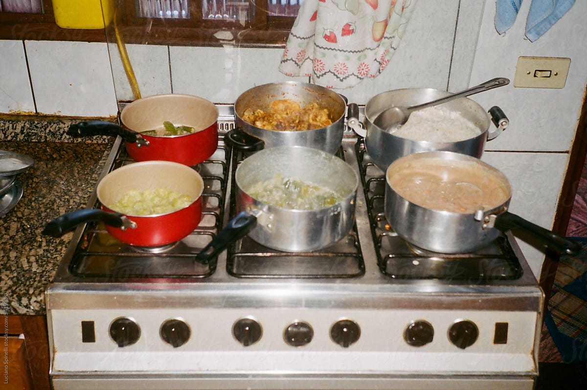 Analog vintage photo of pans on stove cooking complete meal