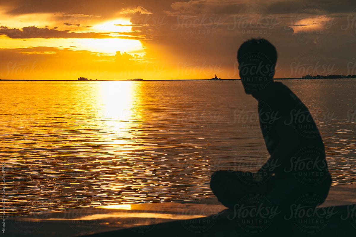 Silhouette of a man at sunset in Manila bay, Philippines