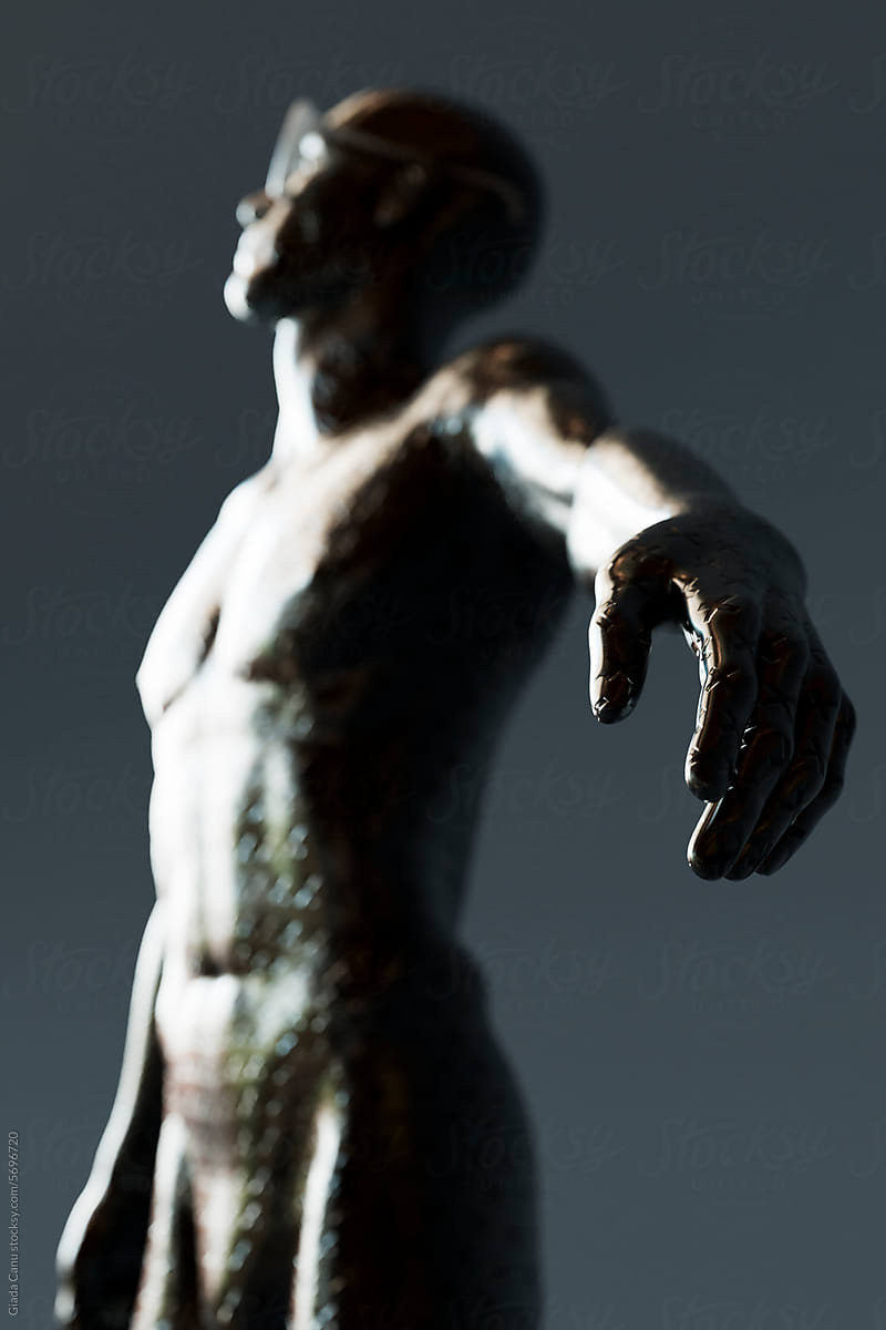metal statue with selective focus on the hand