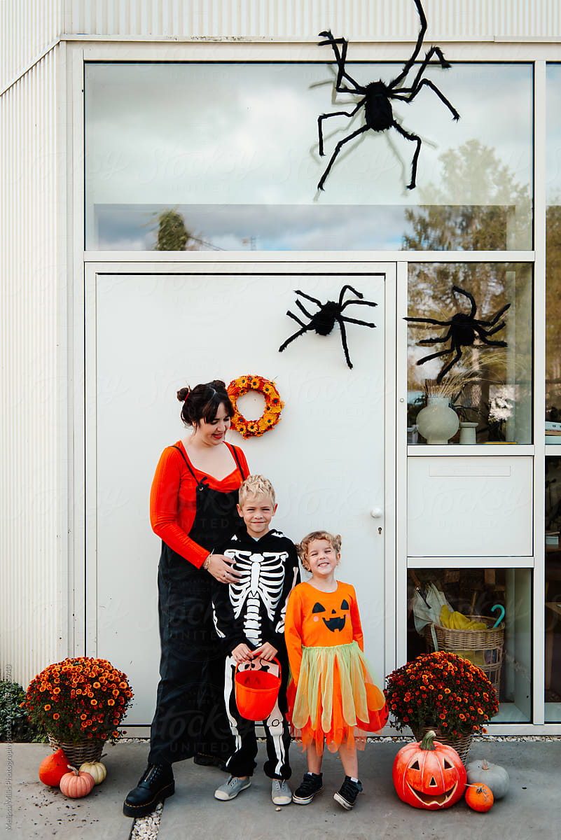 Family in front of home with halloween decorations