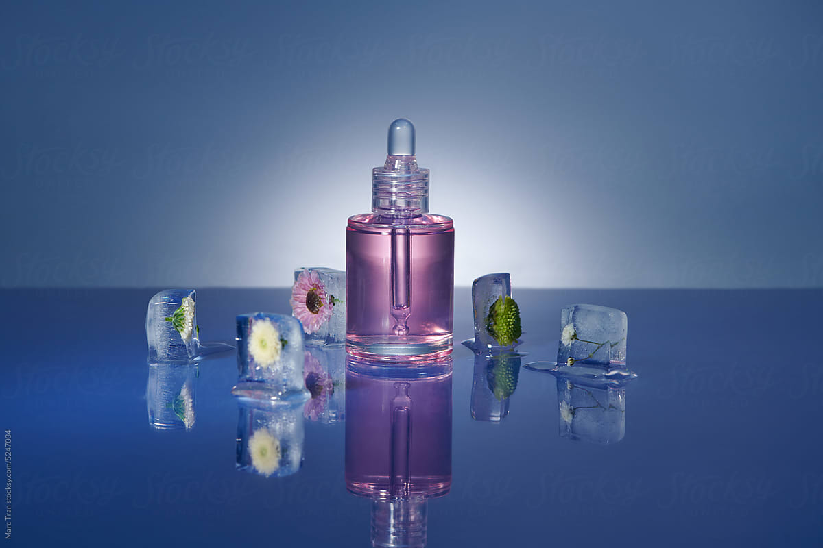 Transparent serum mock up bottle fresh flowers frozen fresh ice cubes