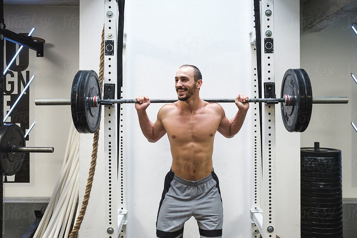 Man Lifting Weights At The Gym by Stocksy Contributor B Krokodil -  Stocksy