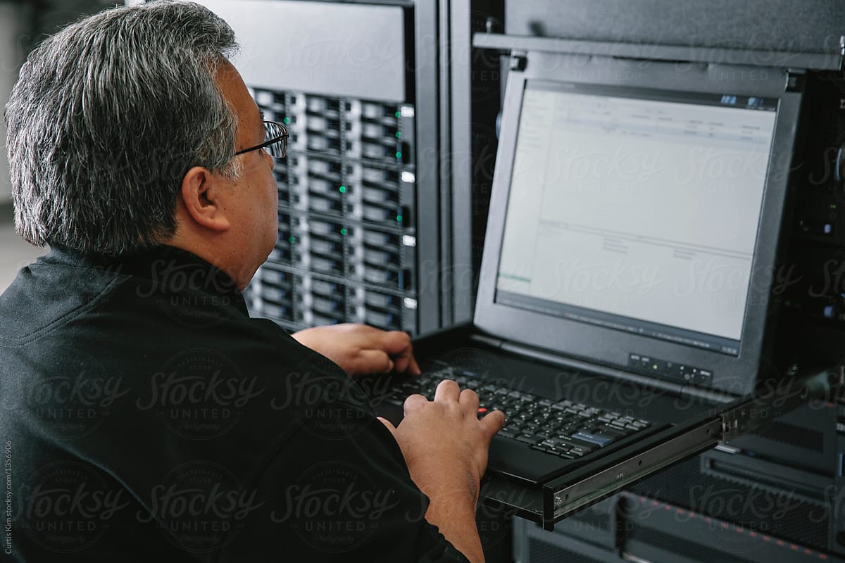 IT programmer working on servers on computer