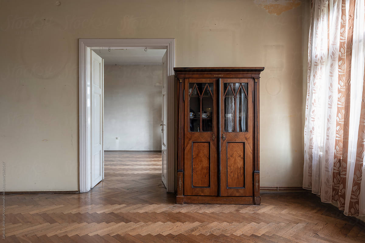 Old wooden wardrobe and open doors in empty home