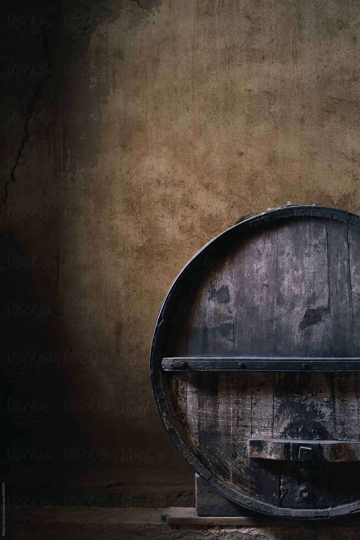 Old wine barrel and beautiful cellar wall