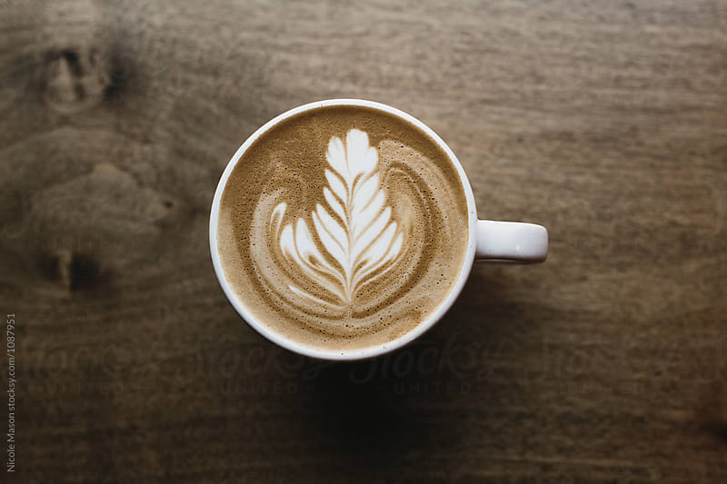 latte art coffee on dark wooden table
