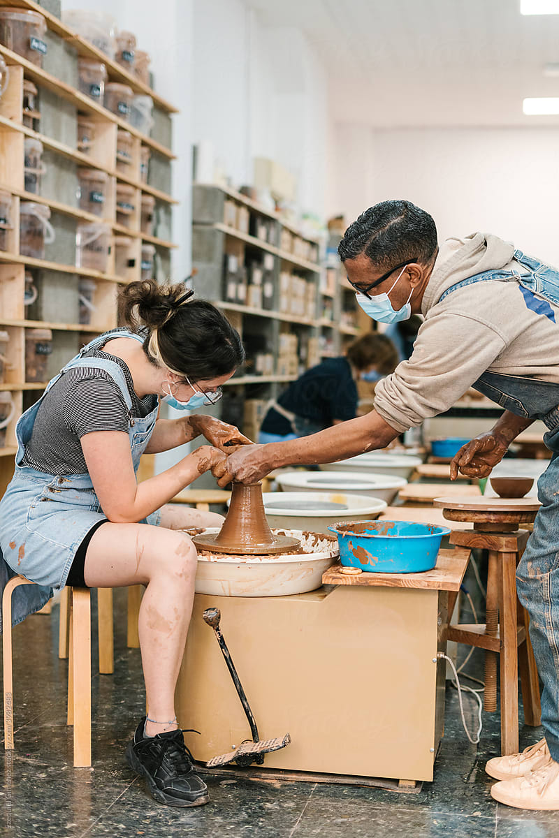 People working in a pottery workshop