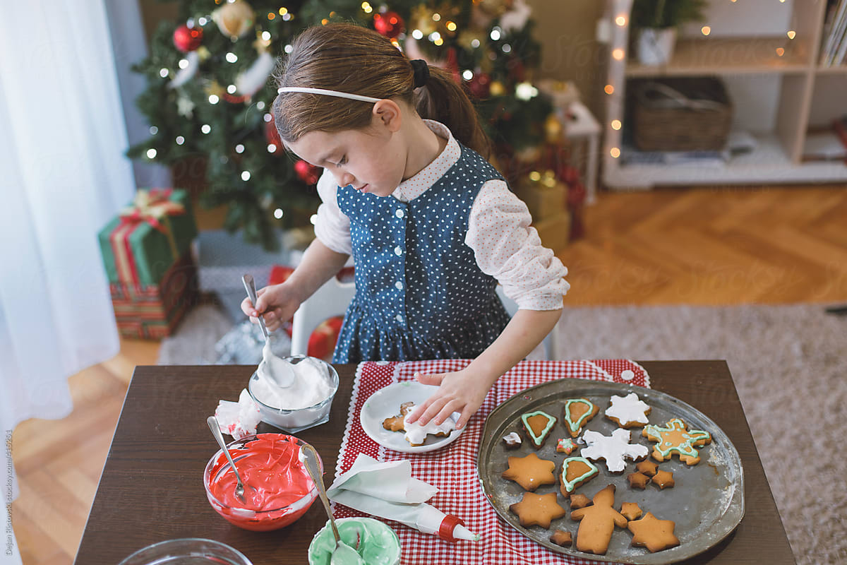 Girl icing Christmas cookies