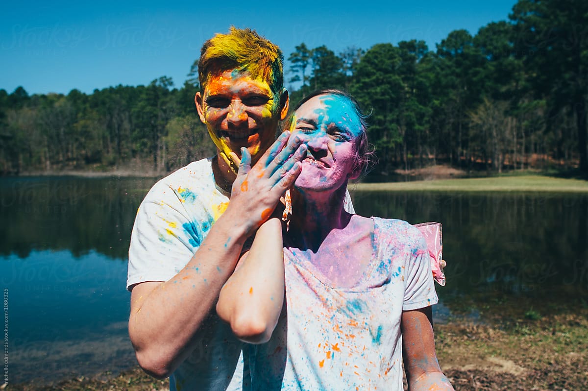 Couple Smearing Colored Powder On Each Other S Faces By Stocksy