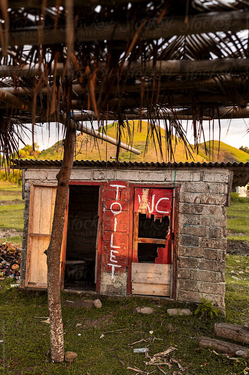 Abandoned Toilet Structure in Rural Landscape