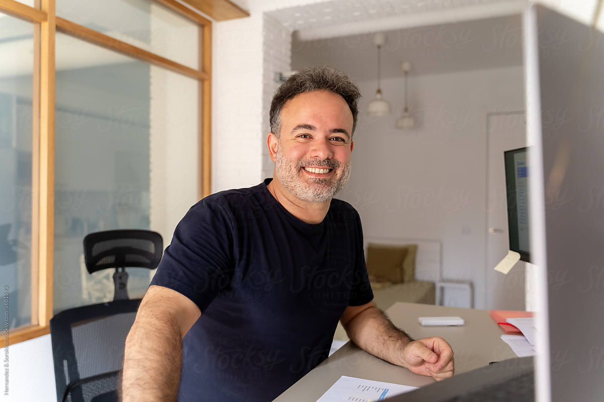 Portrait Of Smiling Man While Working At Home