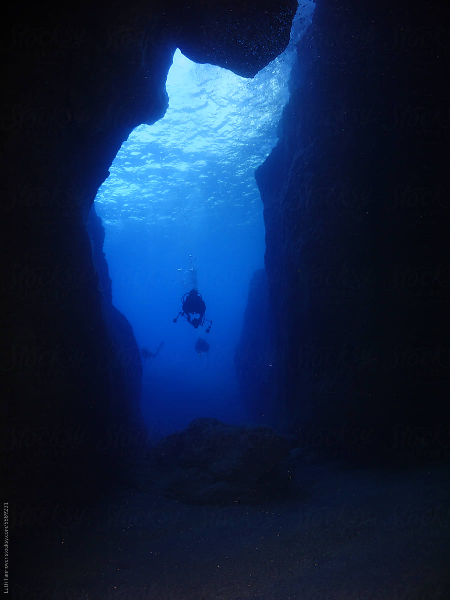 cave diving underwater  with torch light