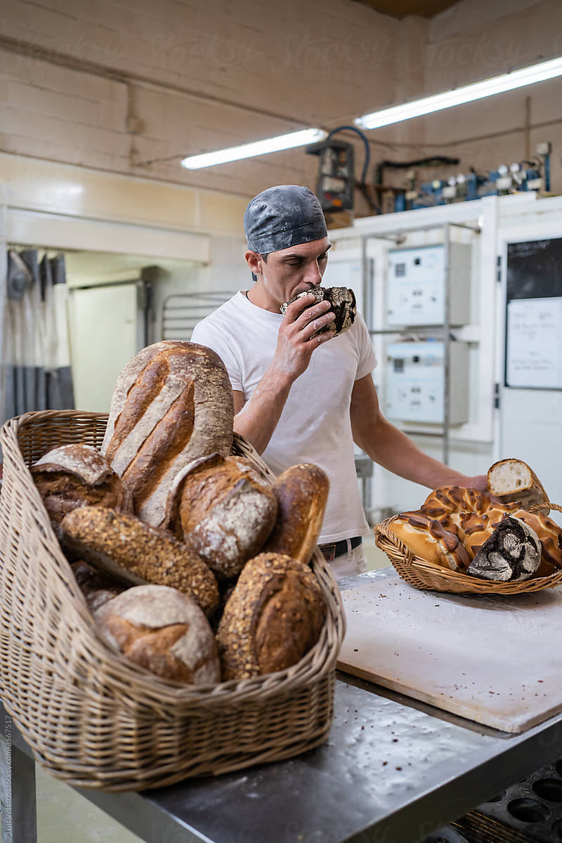 Worker Holding Some Bread In A Local Factory.