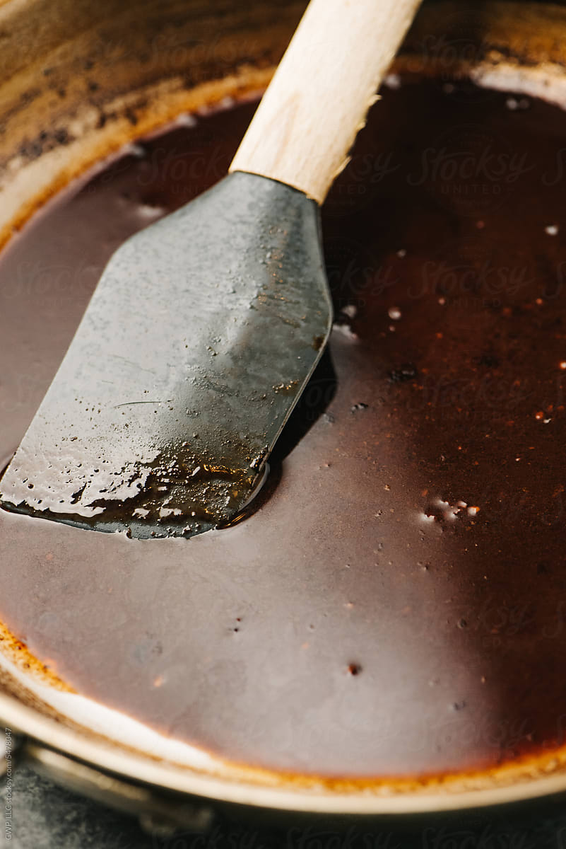 Spatula in a skillet with beef juices