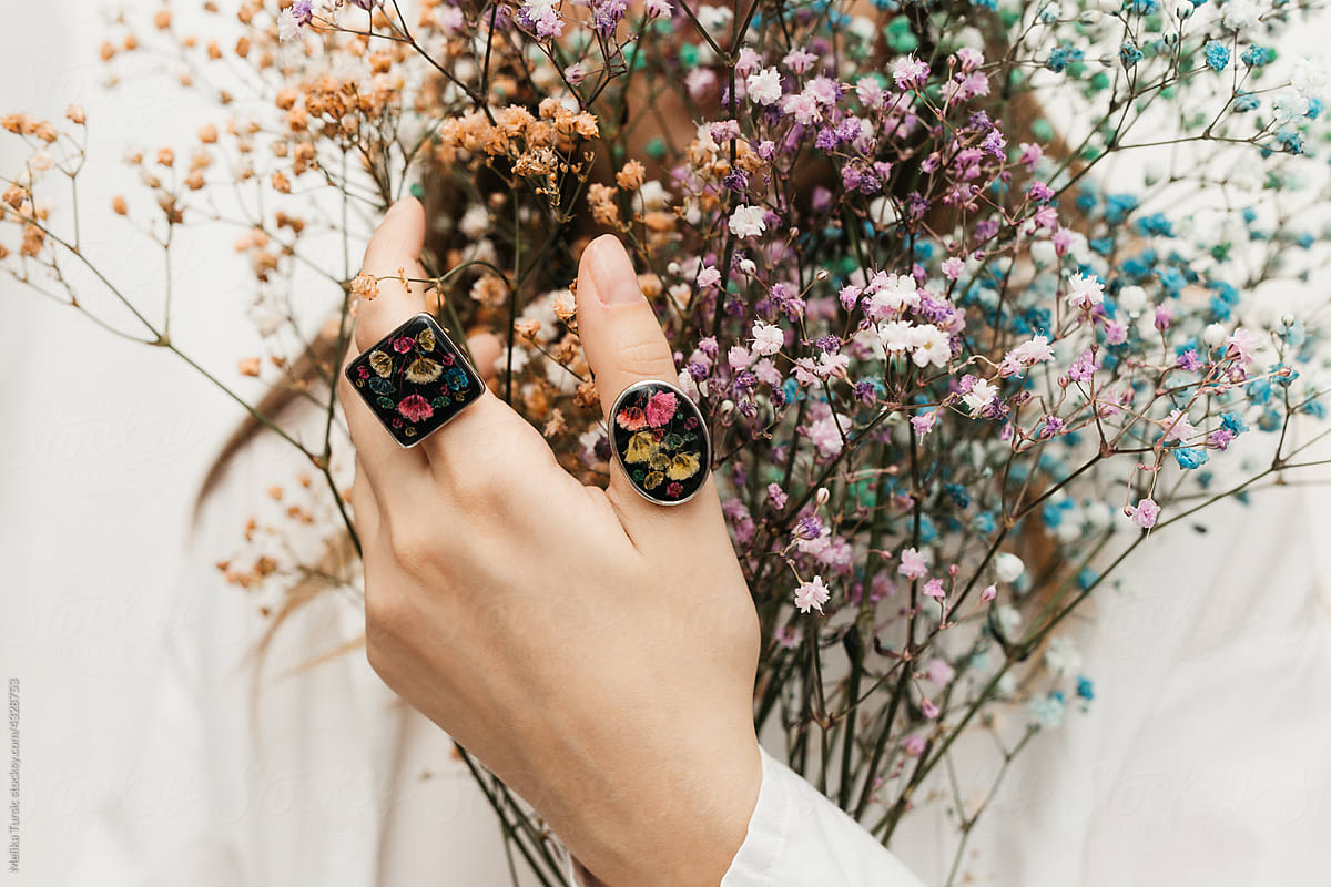 woman wearing floral epoxy rings