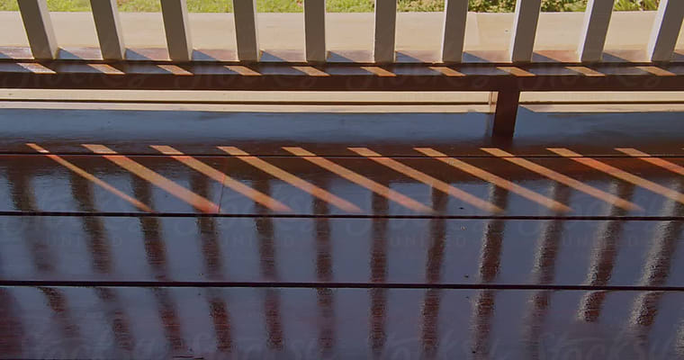 Golden Wood Stain Brush Applied By Hand On Mahogany Deck by Stocksy  Contributor Raymond Forbes LLC - Stocksy