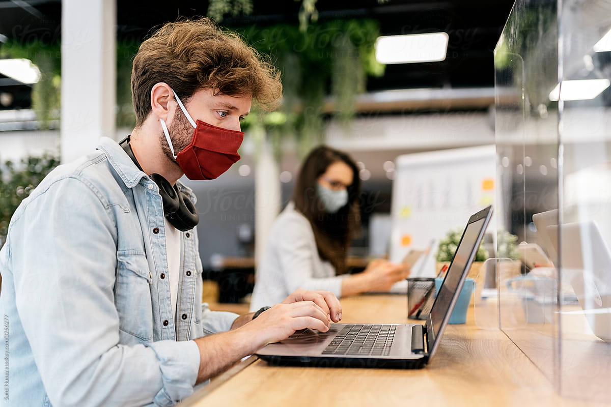 Portrait of Office Workers At Desk Wearing Face Masks