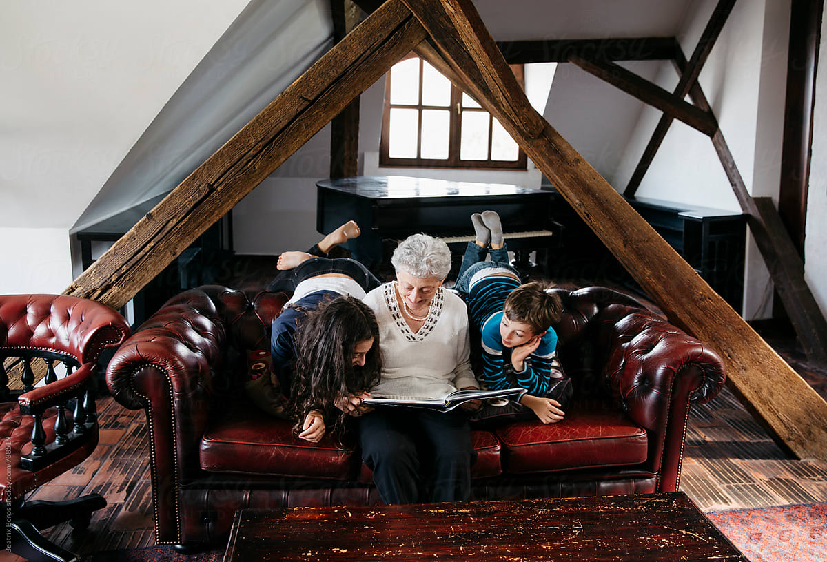 Grandma and grandchildren reading a book together