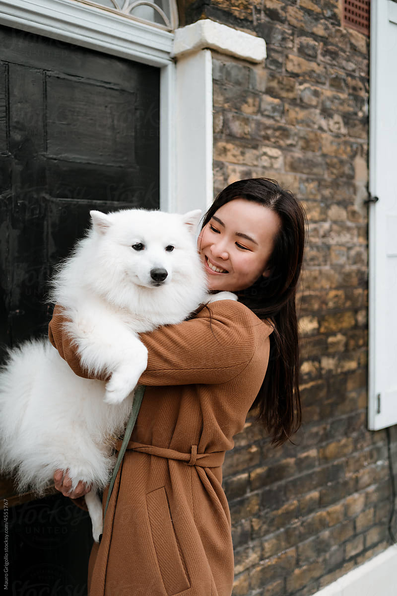 A happy woman loves her dog