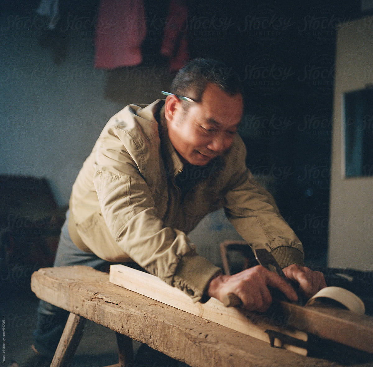 The carpenter is planing wood