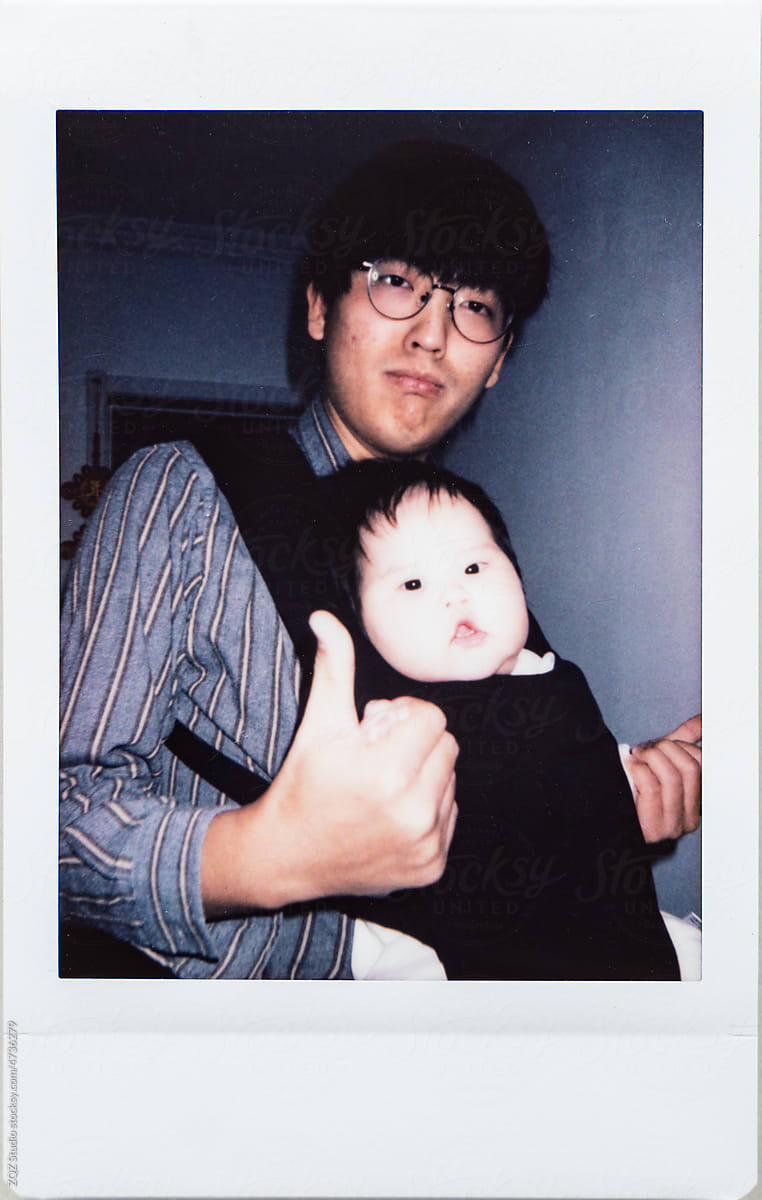Polaroid photo of father and newborn baby girl  by ZQZ Studio for Stocksy United