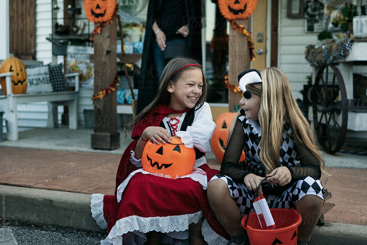 Halloween Girls Sitting On Curb Resting