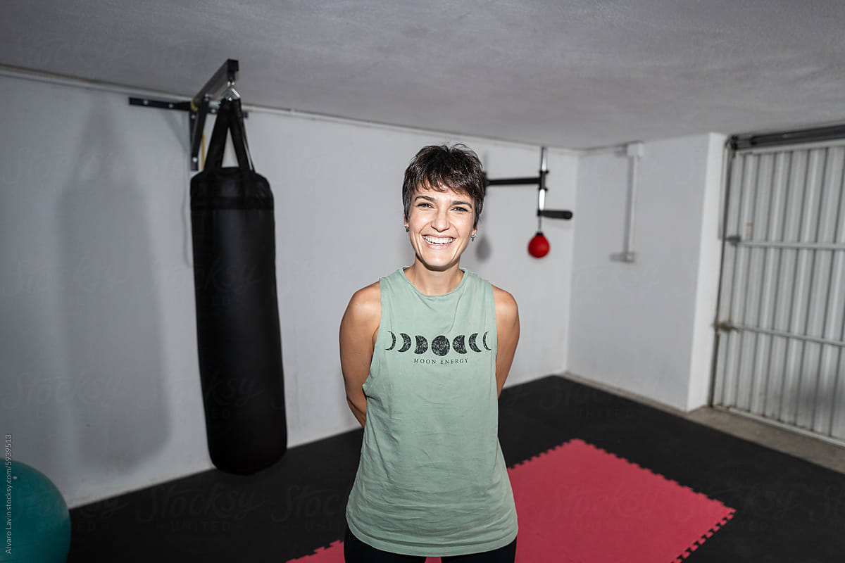 Smiling Woman Exercising in Home Gym
