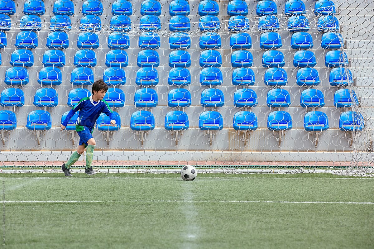 Young football player preparing for a corner kick in a game