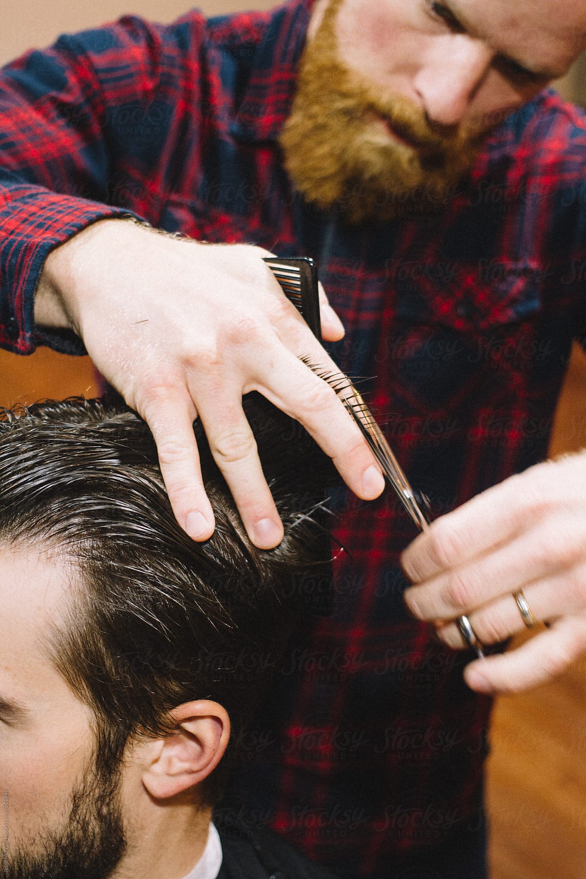 "Barber Cuts Young Male Hair" by Stocksy Contributor "Jesse Morrow
