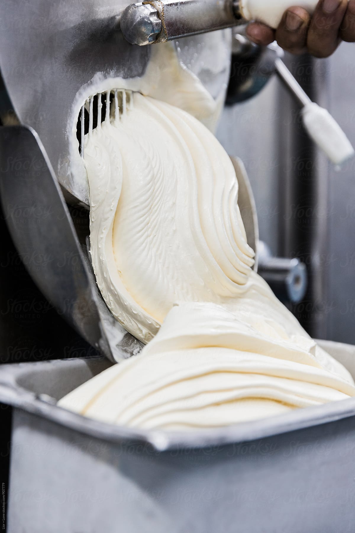 Thick vanilla ice cream following out of industrial machine