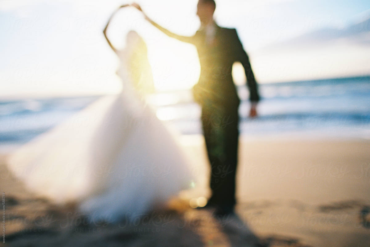 groom twirling bride in sunset in maui hawaii