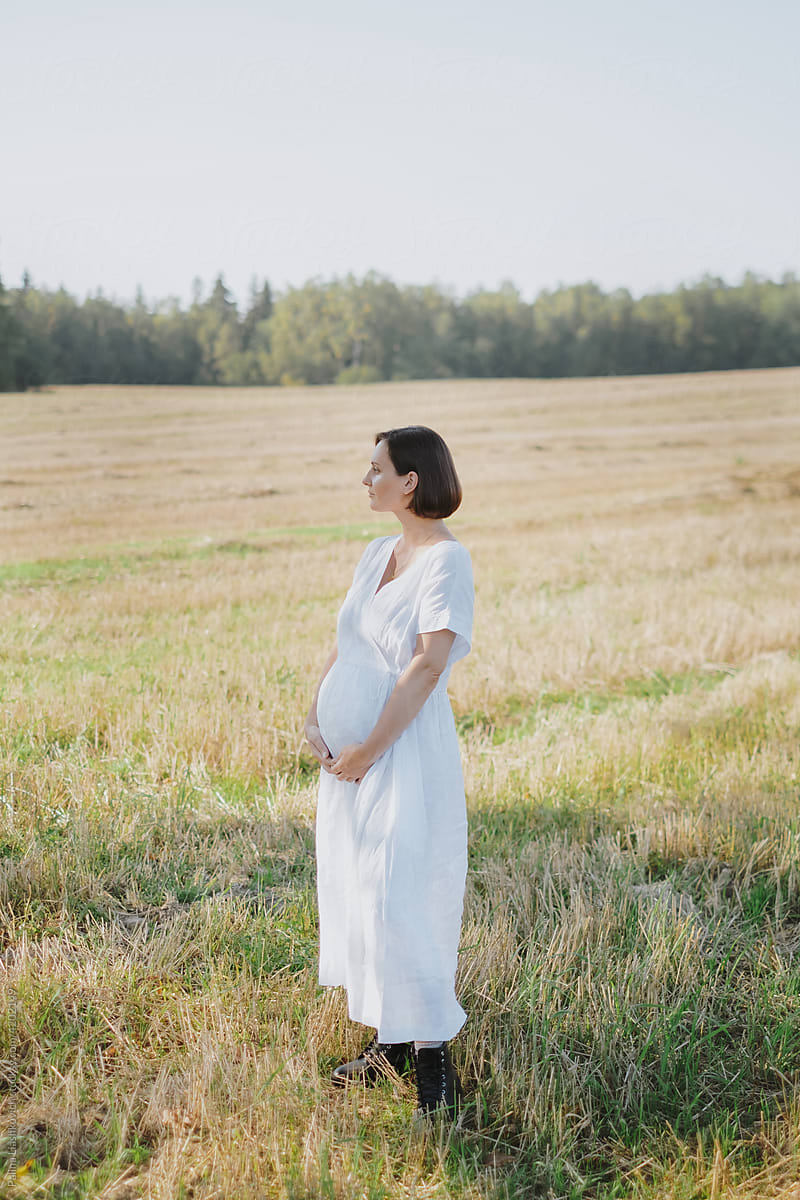 Pregnant woman on the field.