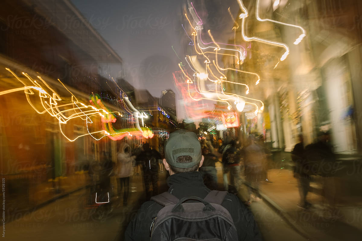 Man Waking Down Crowded Bourbon St in New Orleans at Night