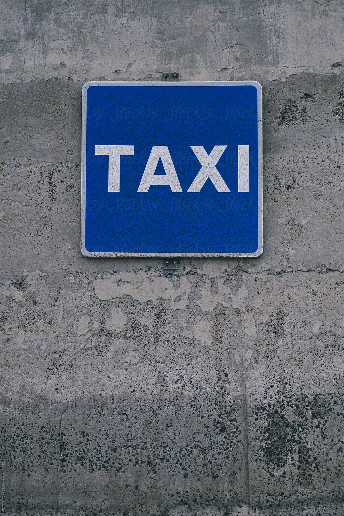 Blue Taxi Sign On a Concrete Grunge Wall