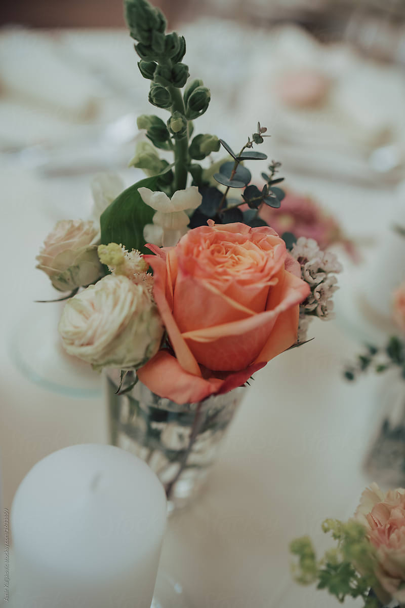 Table centrepiece with orange rose