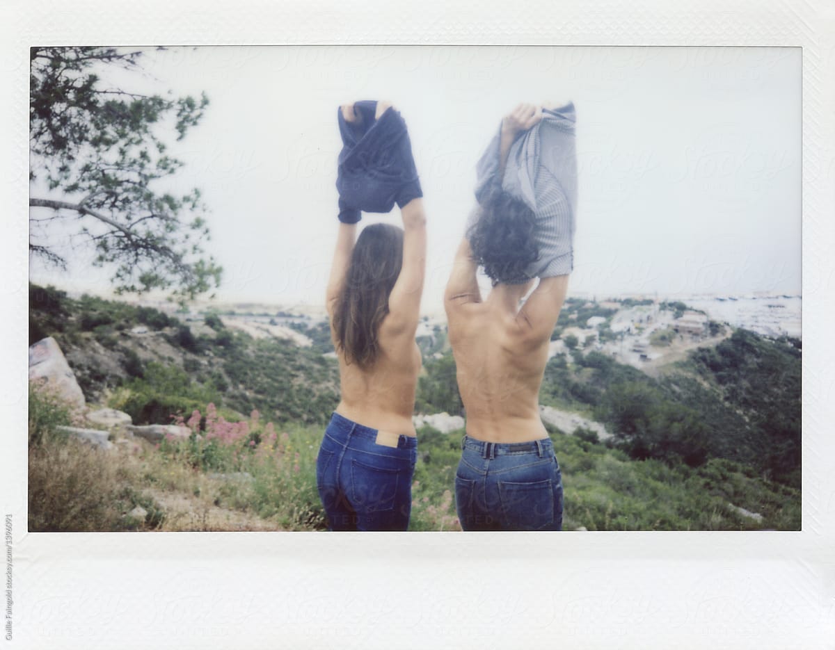 Polaroid of back view of unrecognizable girls taking off their clothes agai...