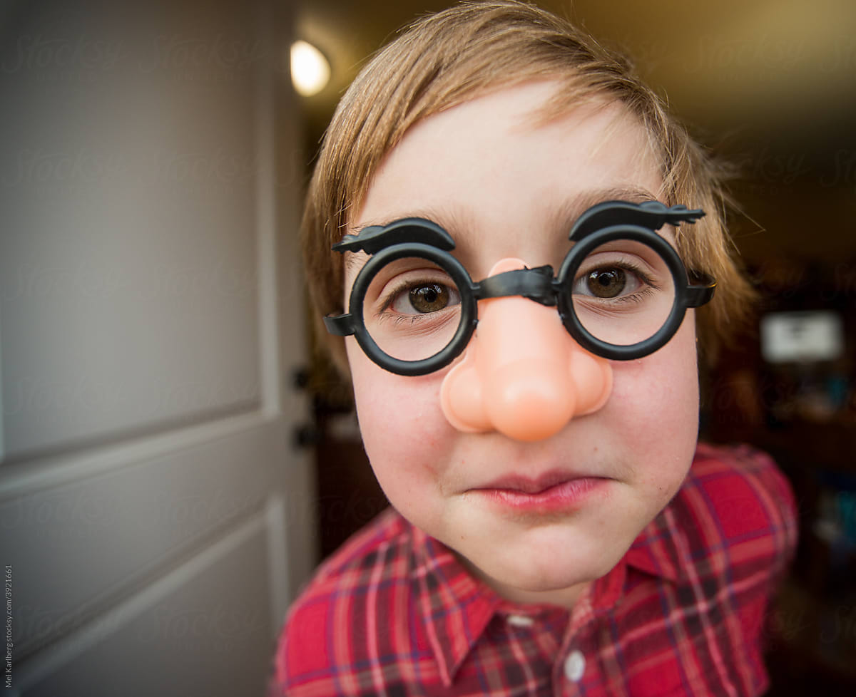 Young boy in funny plastic glasses