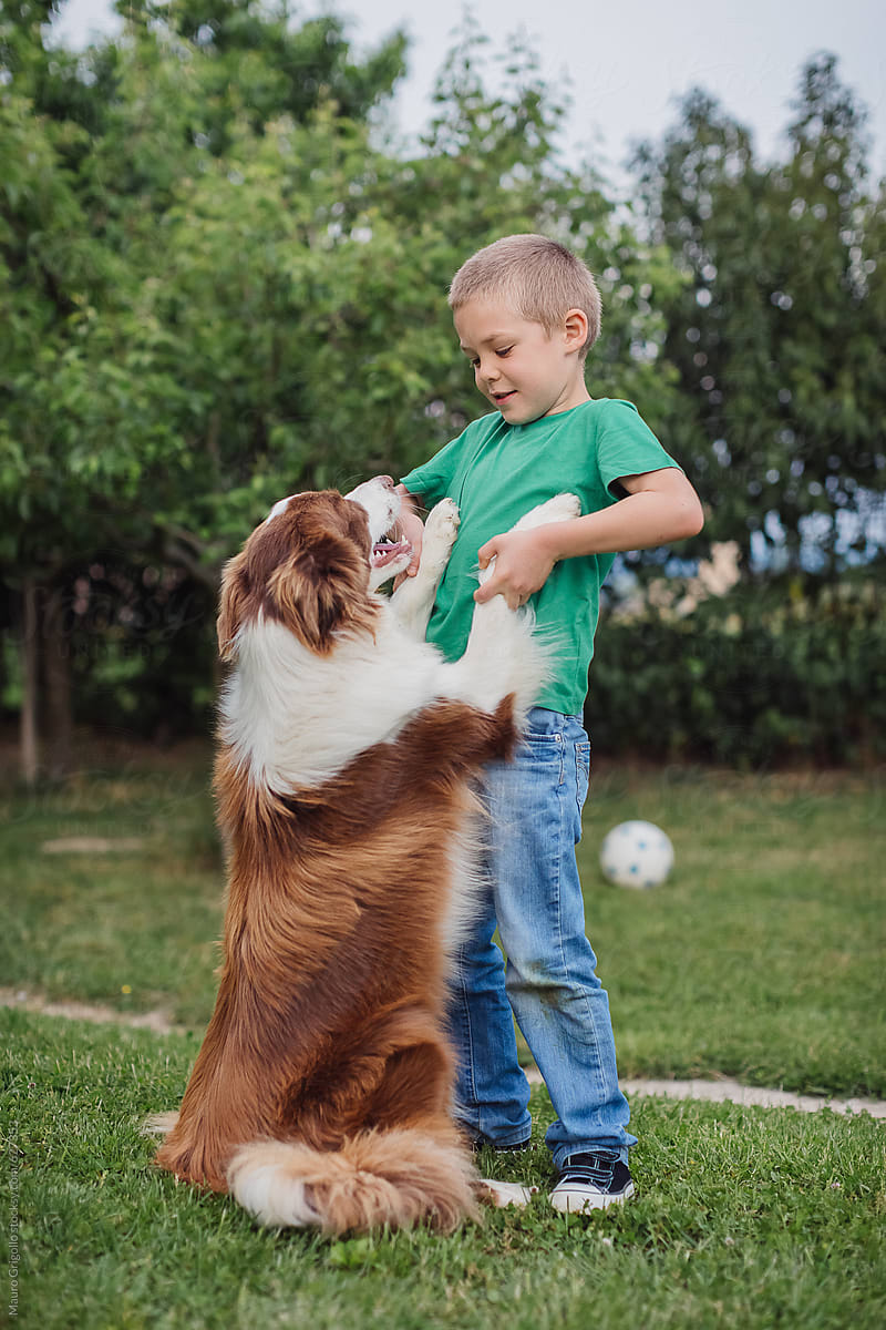 Young boy embraces his friend dog