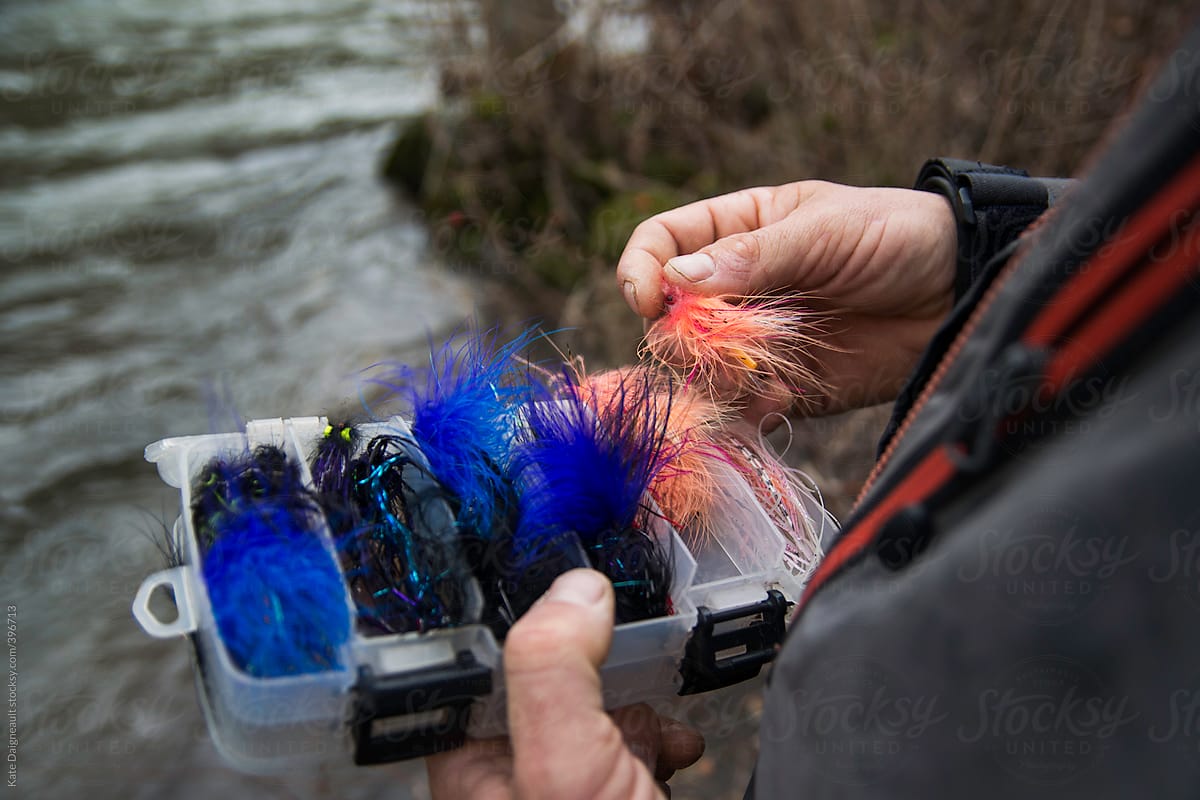 Close up shot of a fly fisherman choosing a fly from his box