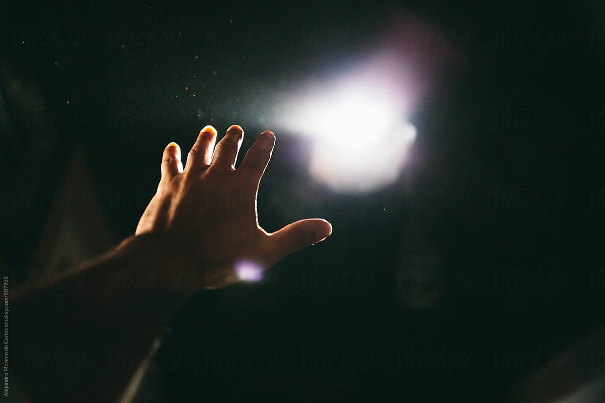 Hand Reaching Light" by Stocksy De Carlos" - Stocksy