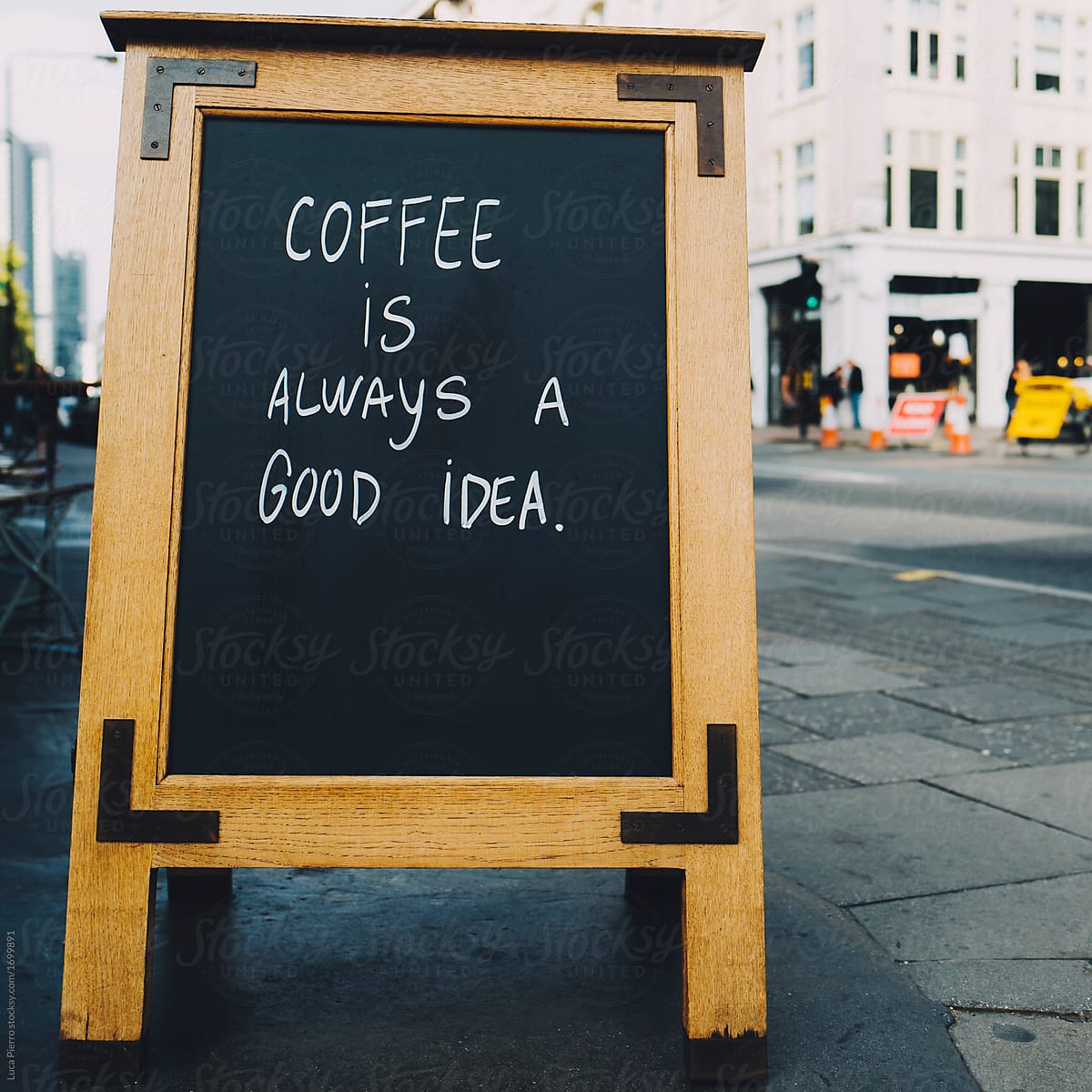 Quote about coffee on a board along the street