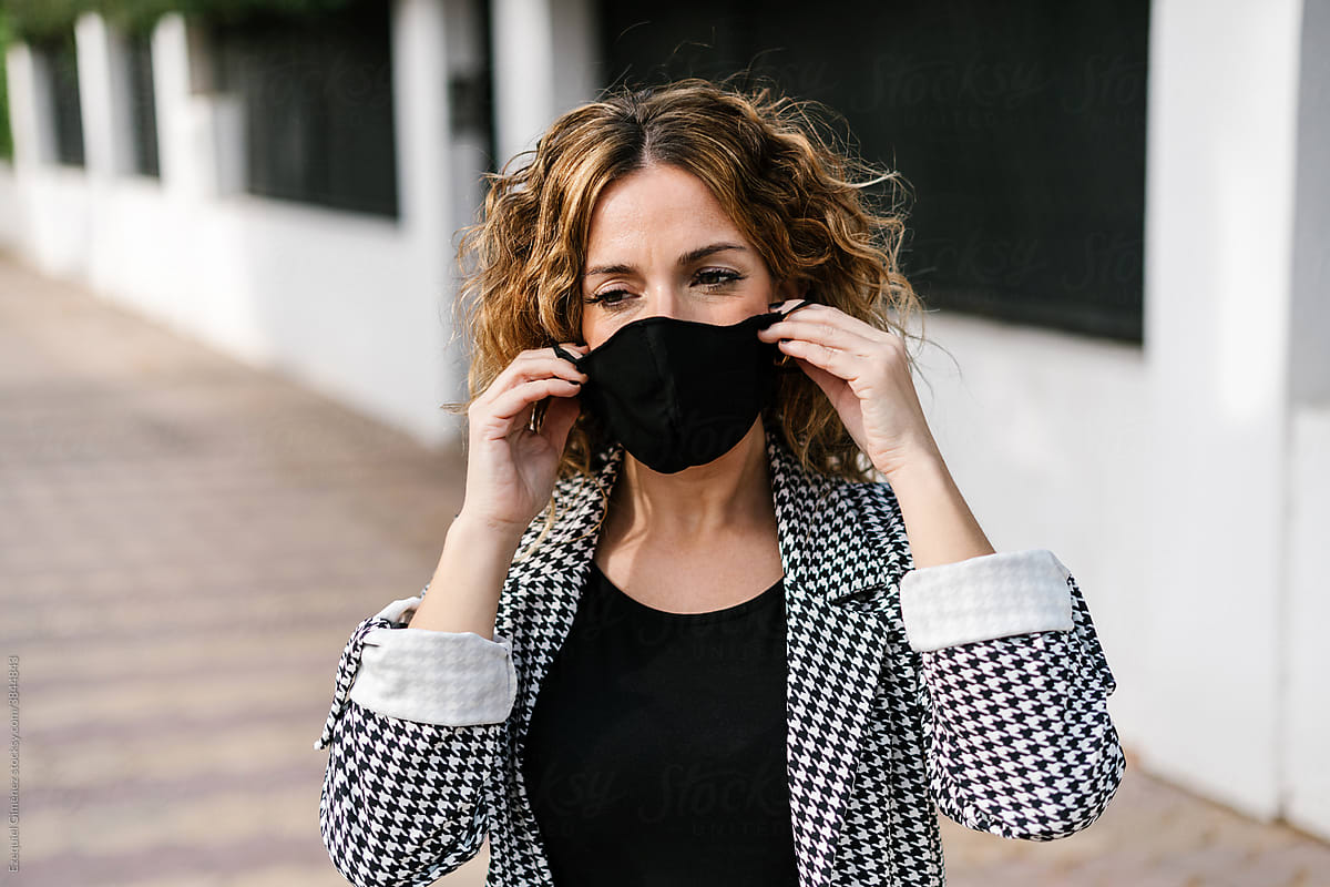 Woman removing protective mask