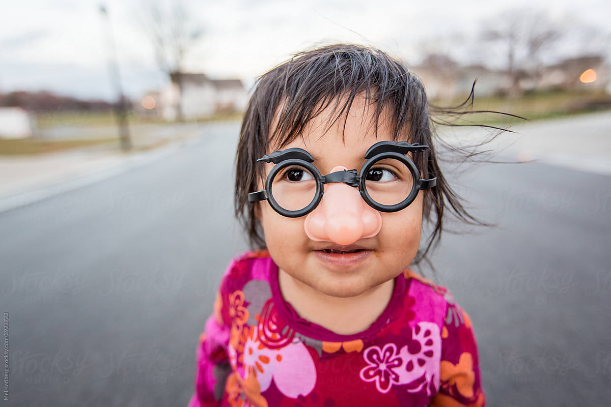 Young girl in funny plastic glasses