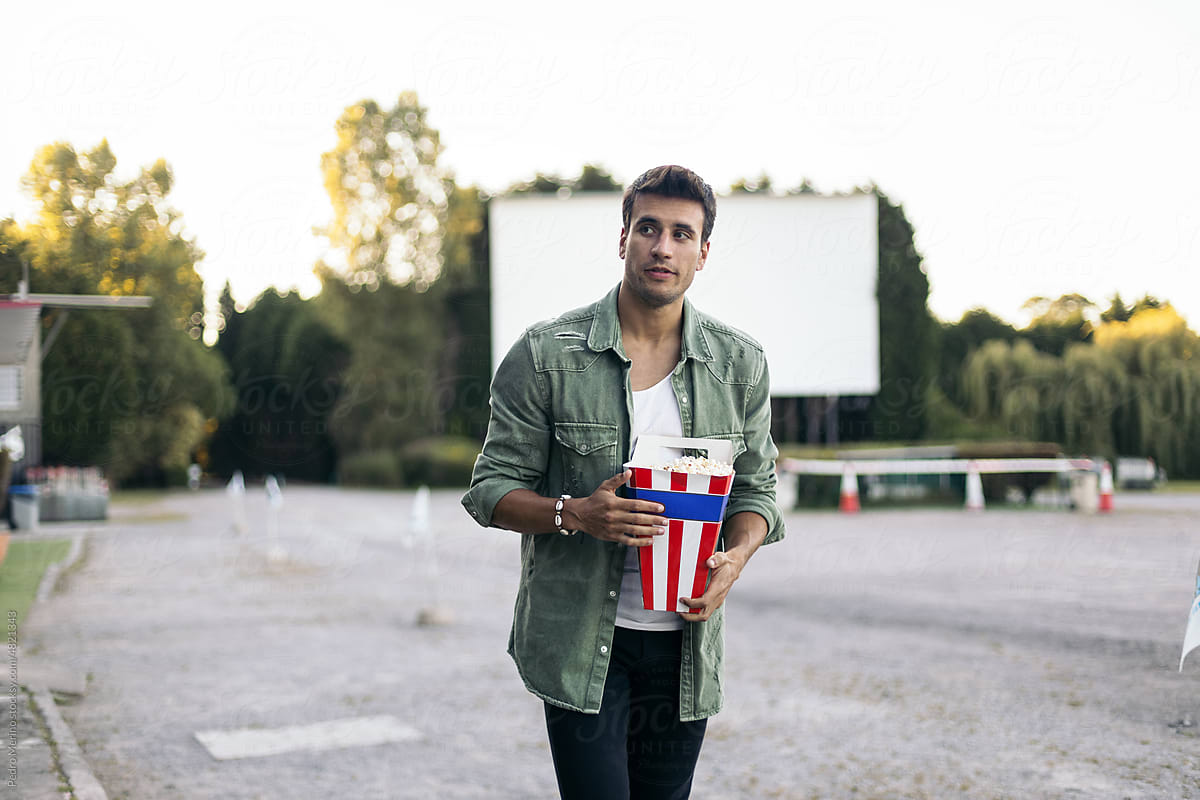 Young man buying popcorn at the drive-in cinema