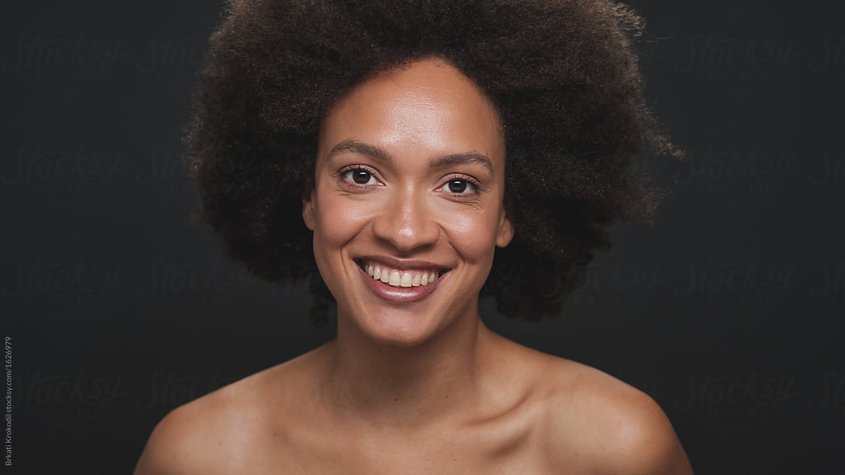 Close Up Portrait Of Smiling Mixed Race Woman With Afro By Stocksy Contributor B Krokodil 