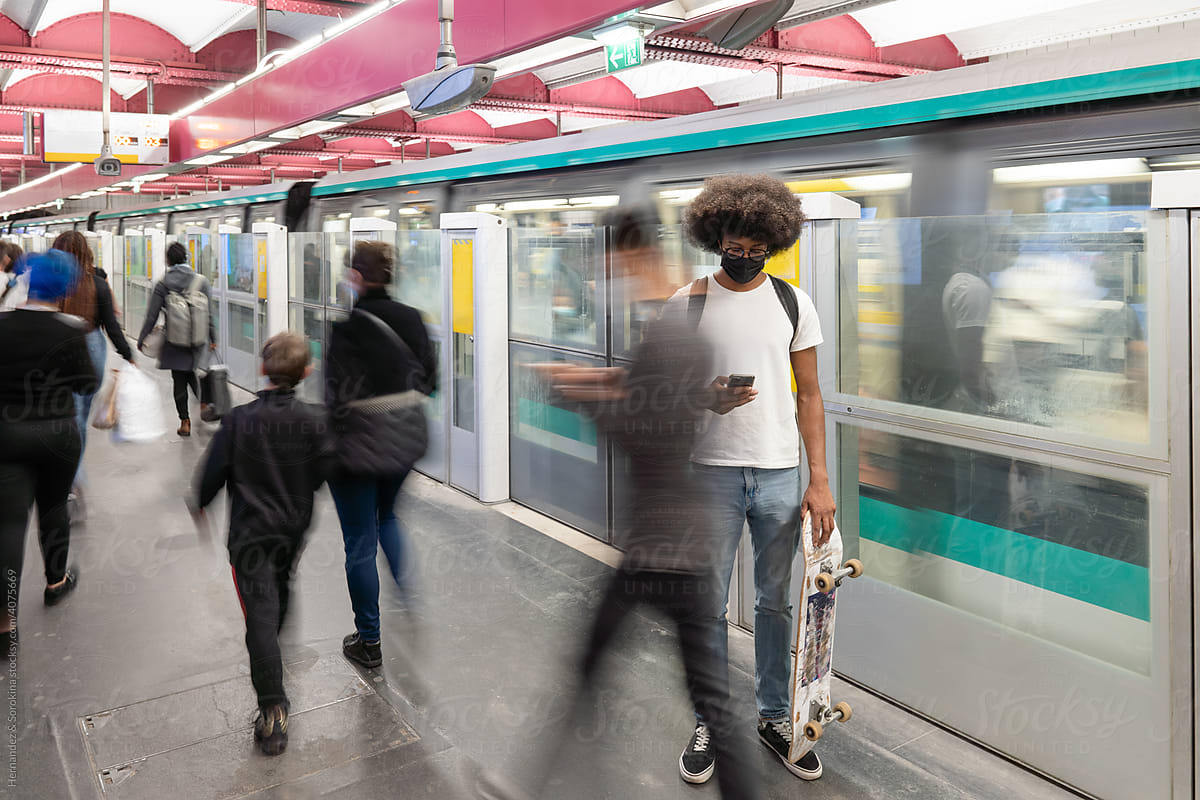 Man With Skateboard At Metro Station