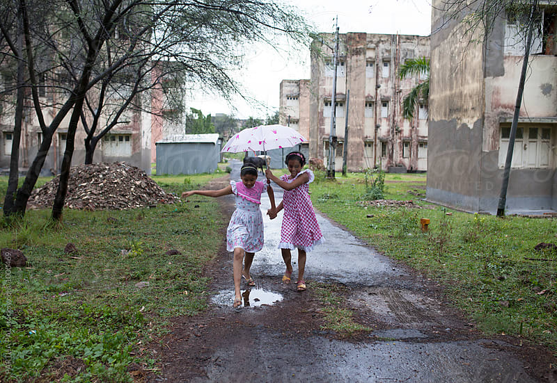 Teenagers with umbrella walking in Monsoon season