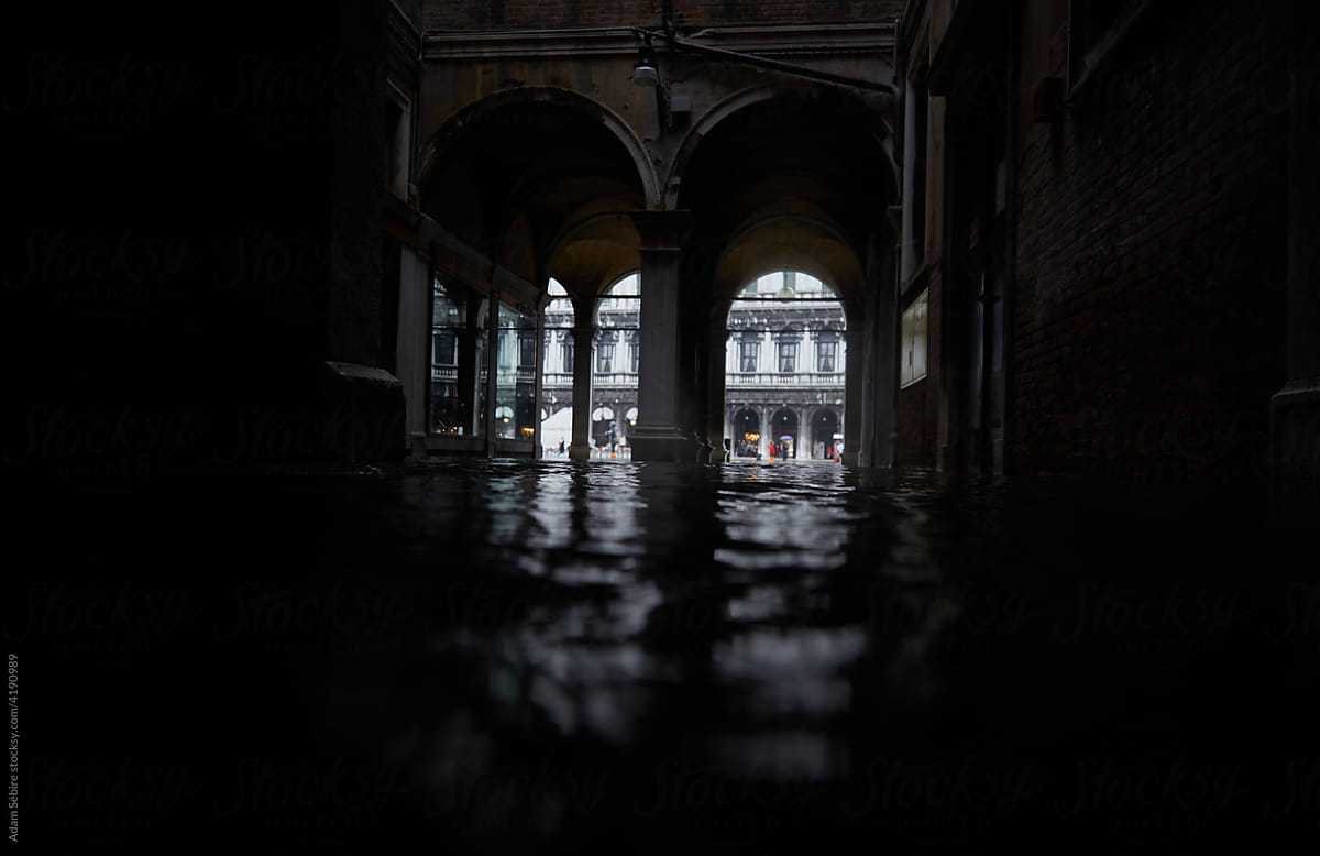 High tide sea water floods Venice - San Marco arches