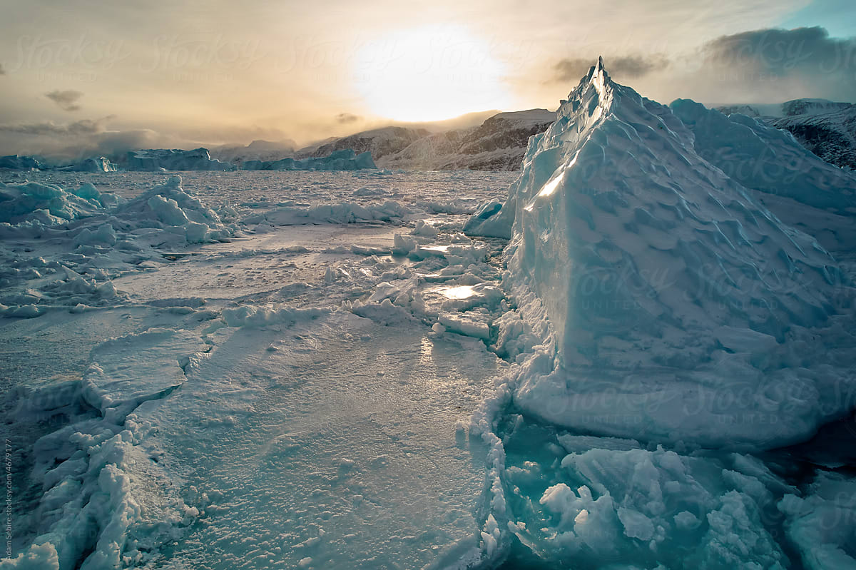 Sun rises after Arctic winter polar night melting iceberg & sea ice